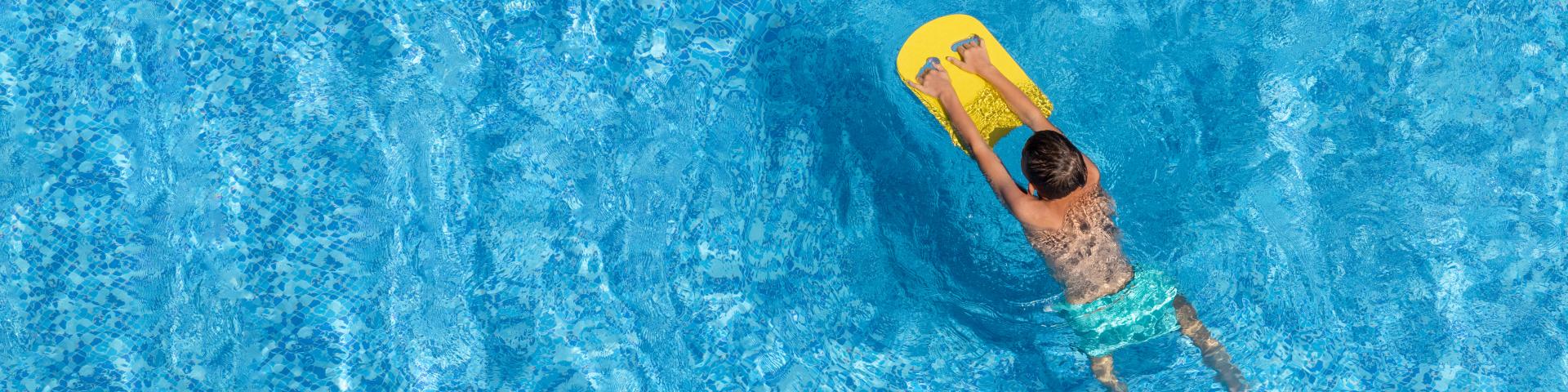 boy swimming with floatie